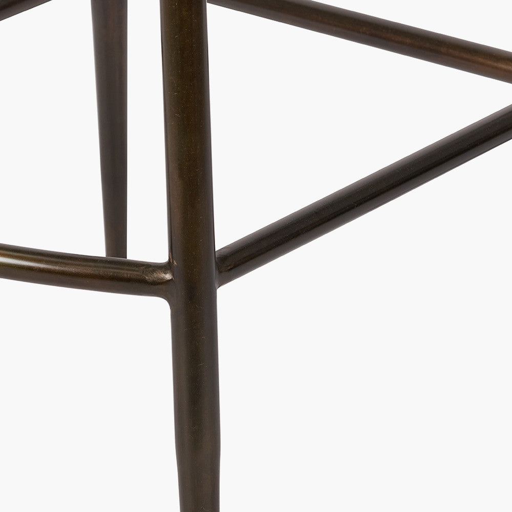 Upholstered in deep peppercorn-toned leather with ribbed cushioning and bronze metal frame, this handcrafted bar stool offers both comfort and visual impact. Shop online today at www.nobleandnook.co.uk