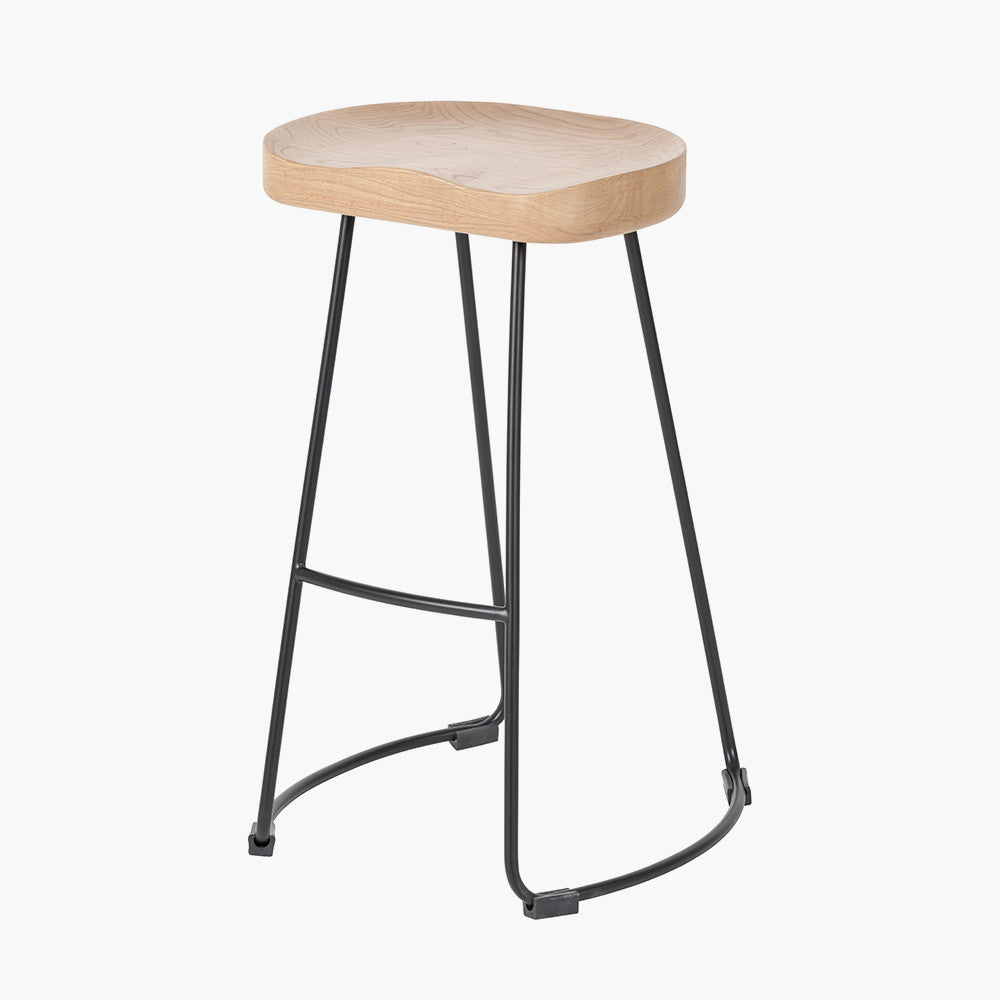 Enhance your seating area with this minimalist bar stool featuring a solid ash wood seat paired with black metal legs, creating a striking contrast that suits contemporary interiors. Shop online today at www.nobleandnook.co.uk