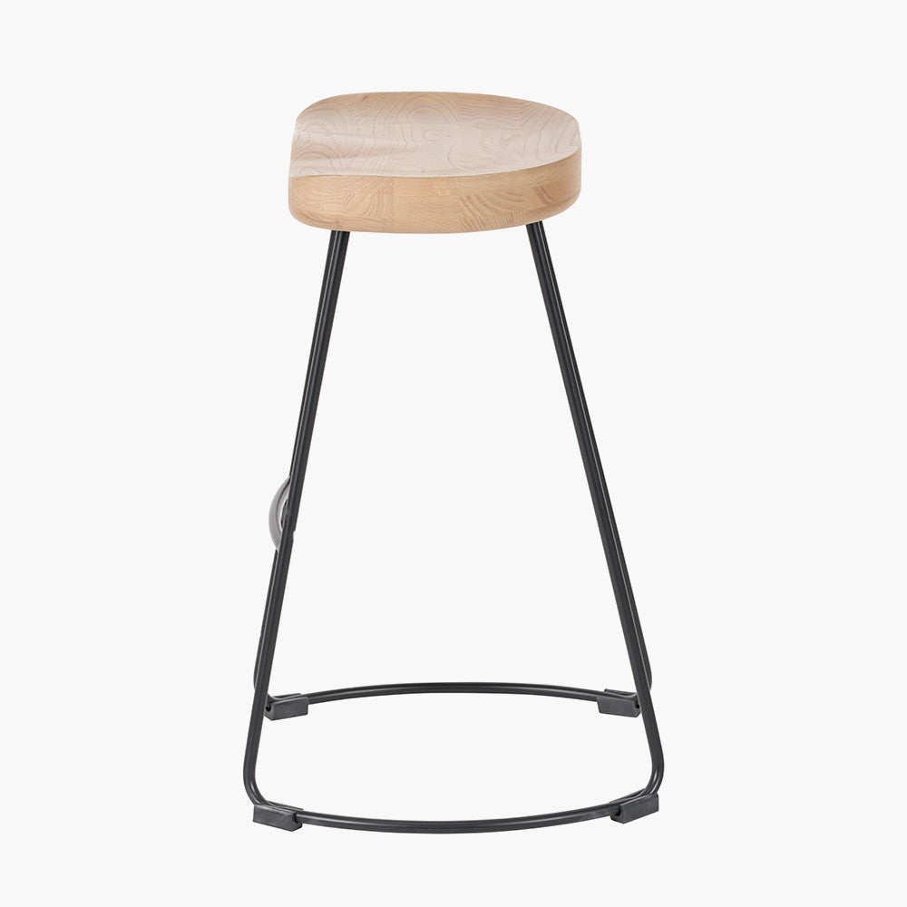 Enhance your seating area with this minimalist bar stool featuring a solid ash wood seat paired with black metal legs, creating a striking contrast that suits contemporary interiors. Shop online today at www.nobleandnook.co.uk