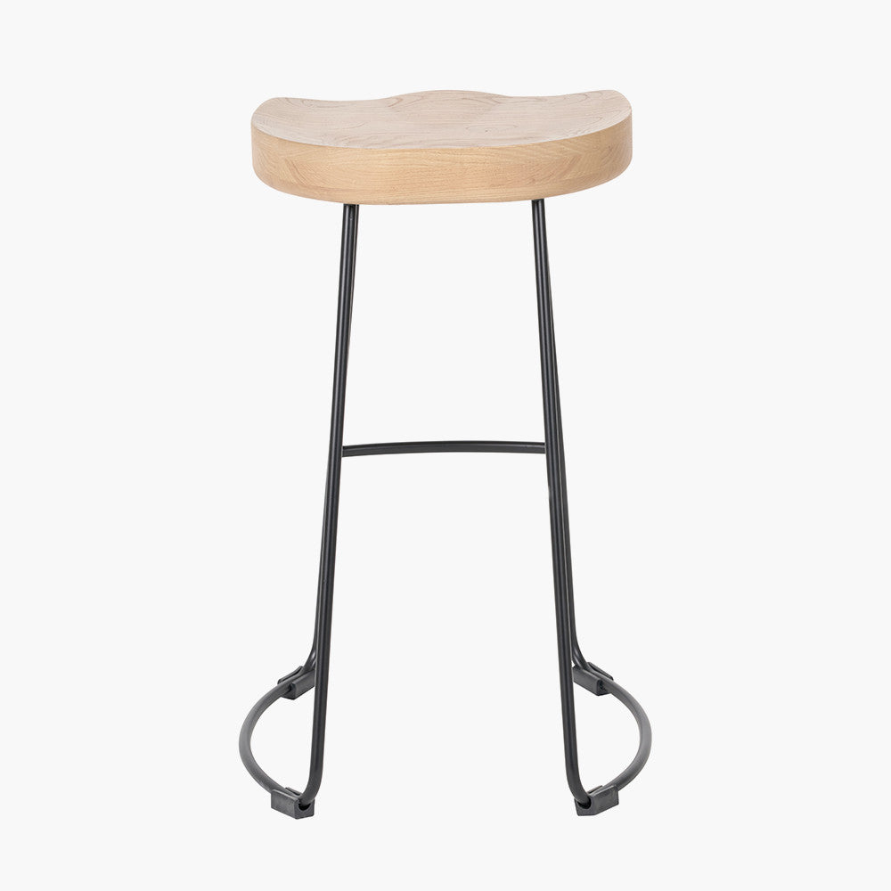 Enhance your seating area with this minimalist bar stool featuring a solid ash wood seat paired with black metal legs, creating a striking contrast that suits contemporary interiors. Shop online today at www.nobleandnook.co.uk