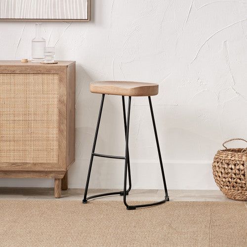 Enhance your seating area with this minimalist bar stool featuring a solid ash wood seat paired with black metal legs, creating a striking contrast that suits contemporary interiors. Shop online today at www.nobleandnook.co.uk