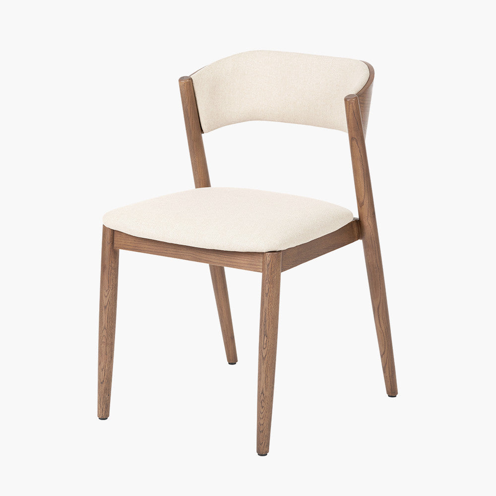 Enhance your dining space with this elegant Scandinavian-inspired dining chair, featuring an dark ash wood frame with the natural linen-effect upholstery. Shop online today at www.nobleandnook.co.uk