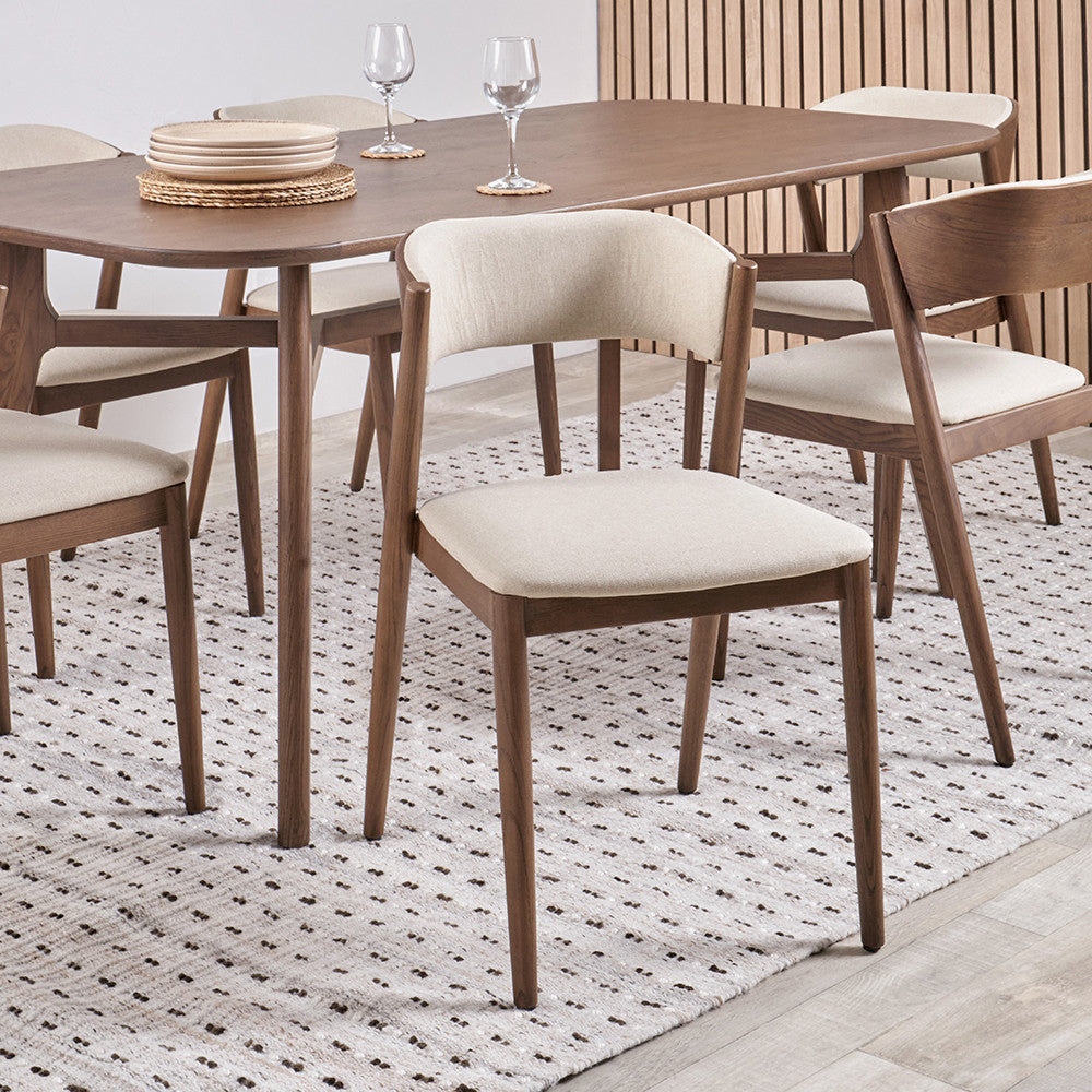 Enhance your dining space with this elegant Scandinavian-inspired dining chair, featuring an dark ash wood frame with the natural linen-effect upholstery. Shop online today at www.nobleandnook.co.uk