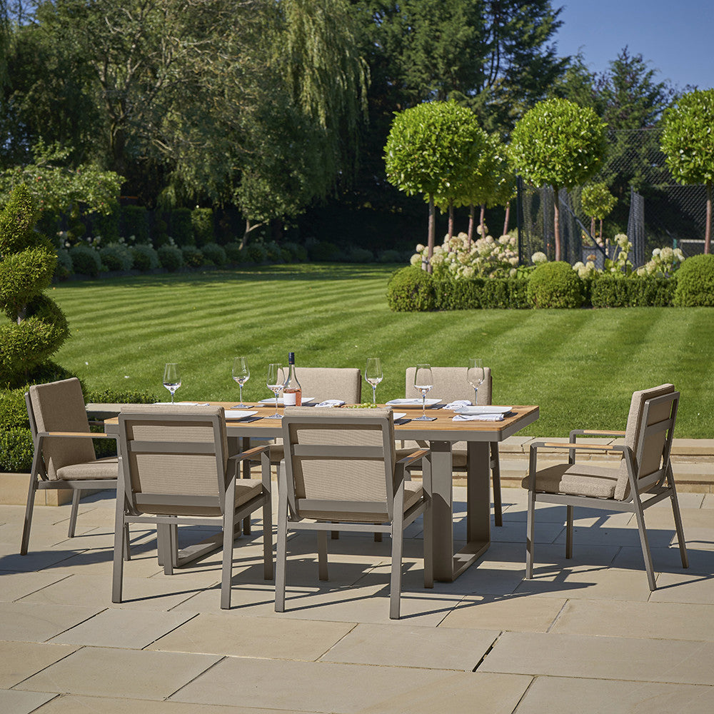 Transform your garden with the Stockholm 6 Seater Limestone Outdoor Dining Set, powder coated aluminium frame with natural Teak Wood accents. Shop online today at www.nobleandnook.co.uk