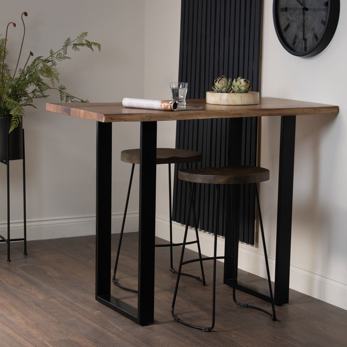 The Live Edge Small Bar Table is a stunning centrepiece for any home bar or entertainment space. Crafted from Indian hardwood (acacia) paired with a sleek metal base. Shop online today at www.nobleandnook.co.uk