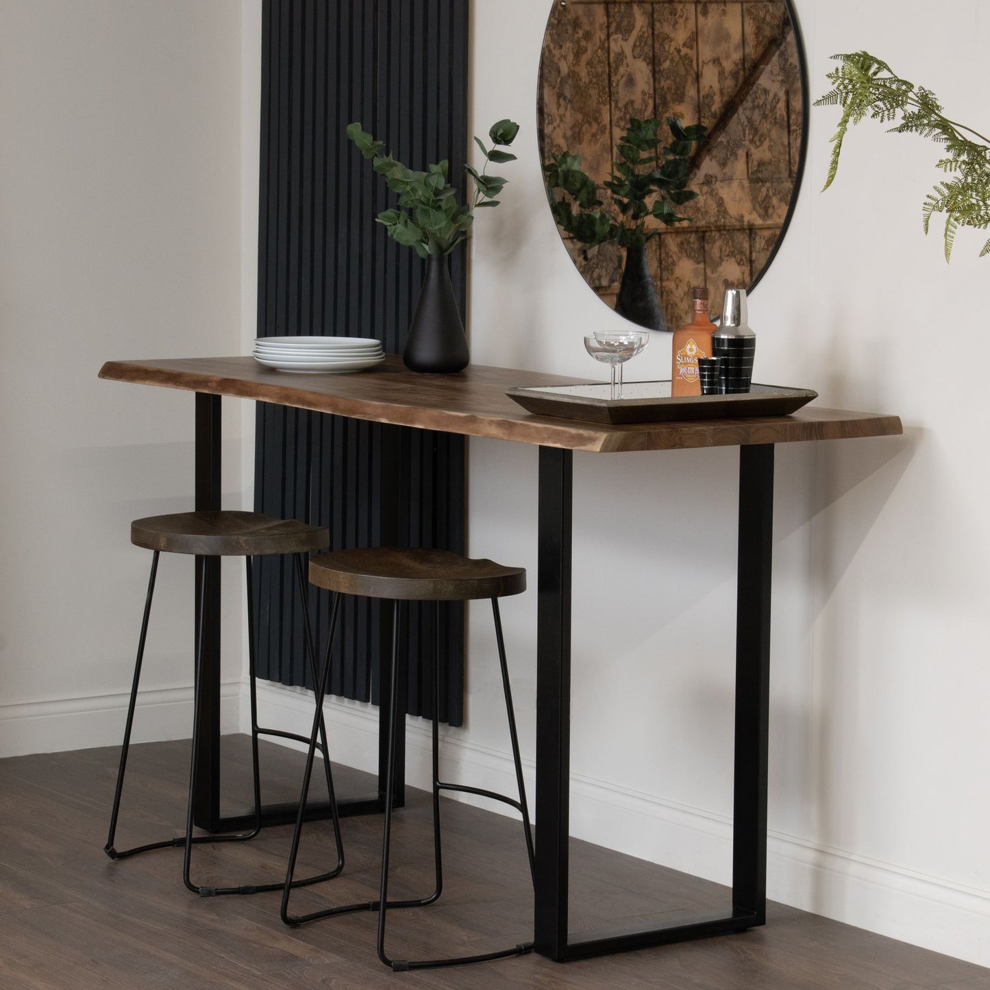 The Live Edge Large Bar Table is a stunning centrepiece for any home bar or entertainment space. Crafted from Indian hardwood (acacia) paired with a sleek metal base. Shop online today at www.nobleandnook.co.uk