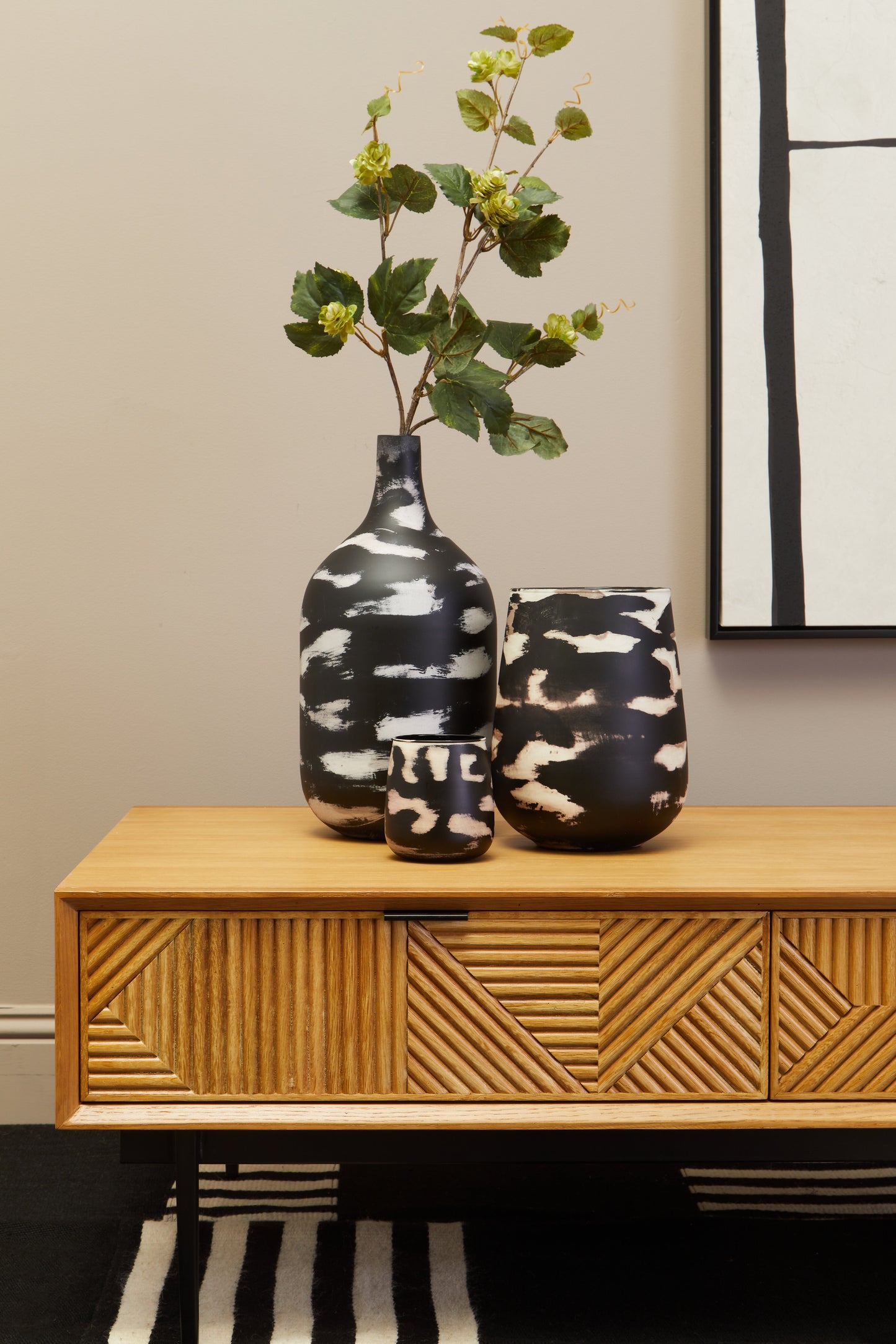 The Kajara Coffee Table pairs a natural carved wood finish with clean black metal legs, offering an elegant balance between rustic charm and modern minimalism. Shop online today at www.nobleandnook.co.uk