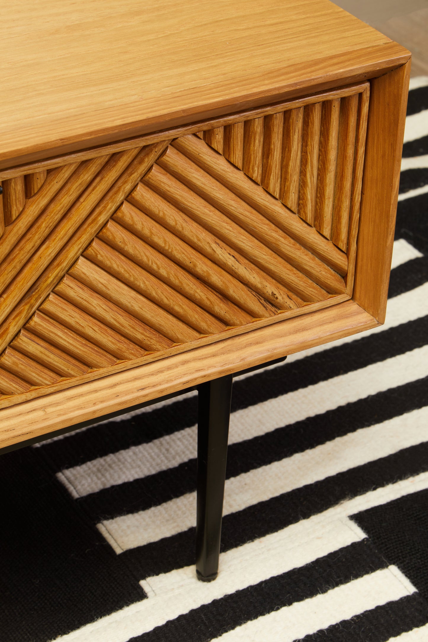 The Kajara Coffee Table pairs a natural carved wood finish with clean black metal legs, offering an elegant balance between rustic charm and modern minimalism. Shop online today at www.nobleandnook.co.uk