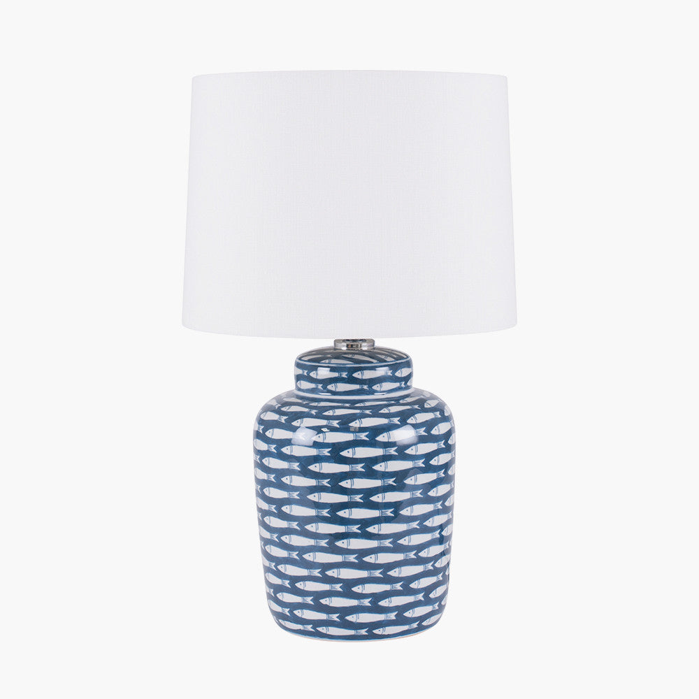 Shop Ceramic Base with repeated fish motif with soft yet striking presence tapered cream cotton shade. Perfect for coastal or nautical interiors. Shop online today at www.nobleandnook.co.uk