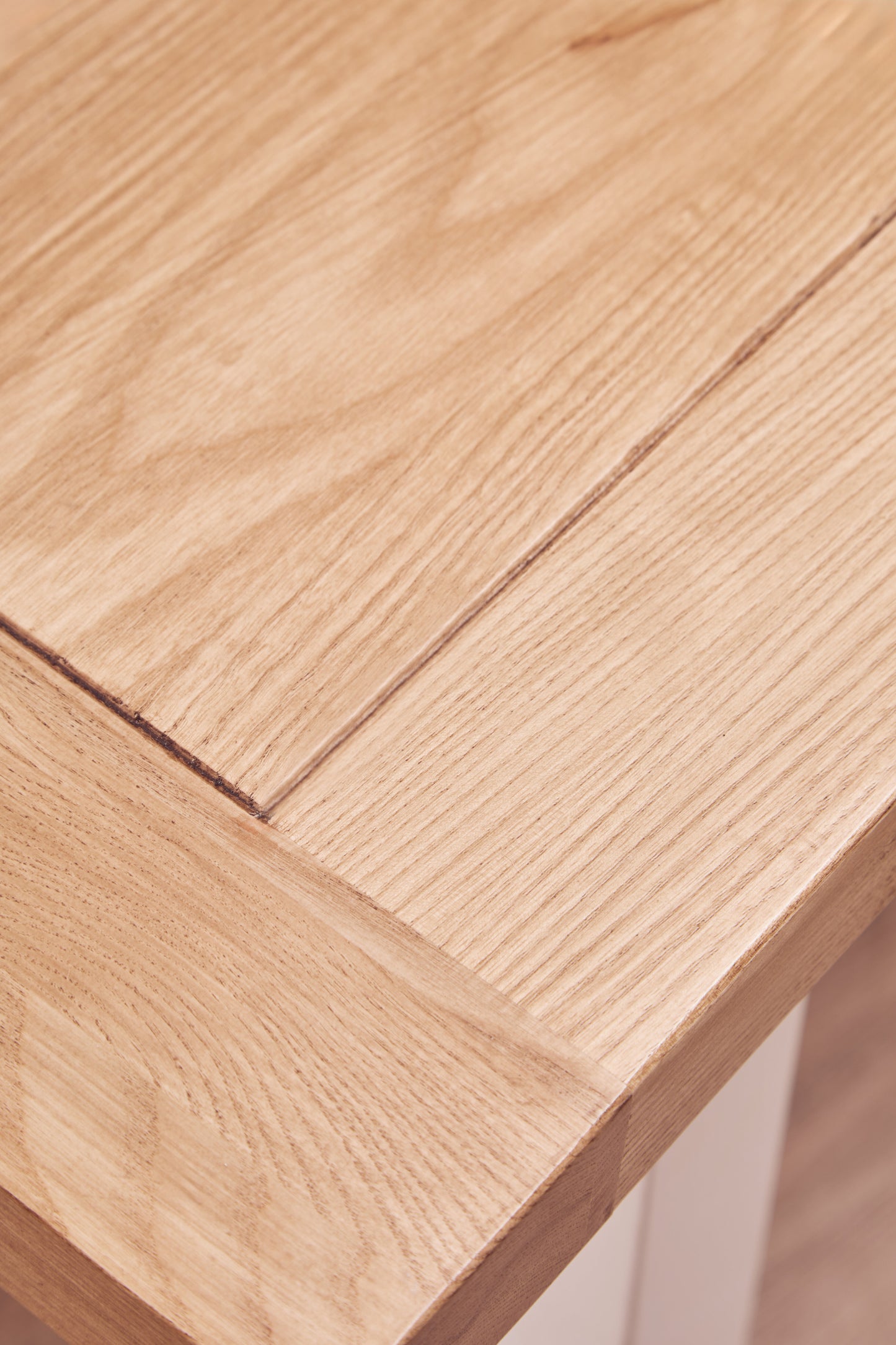 A timeless centrepiece, the Riverside Dining Table features a reclaimed natural oak wood top paired with a white-finished birch wood base. Shop online today at www.nobleandnook.co.uk