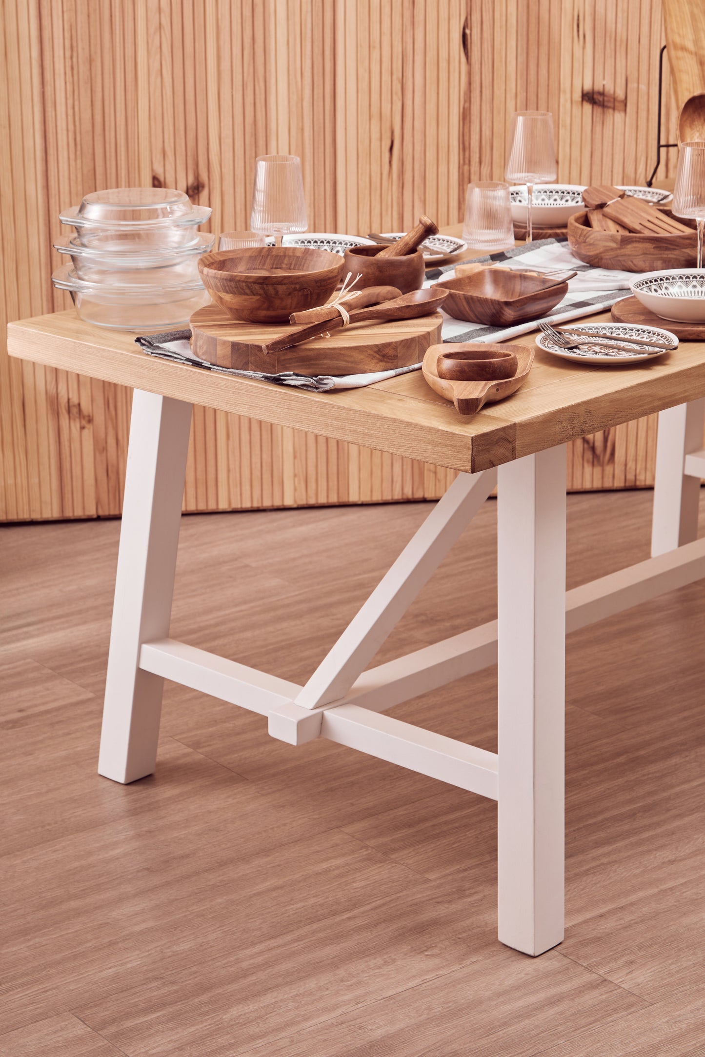 A timeless centrepiece, the Riverside Dining Table features a reclaimed natural oak wood top paired with a white-finished birch wood base. Shop online today at www.nobleandnook.co.uk
