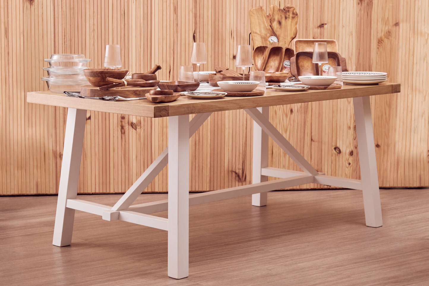 A timeless centrepiece, the Riverside Dining Table features a reclaimed natural oak wood top paired with a white-finished birch wood base. Shop online today at www.nobleandnook.co.uk