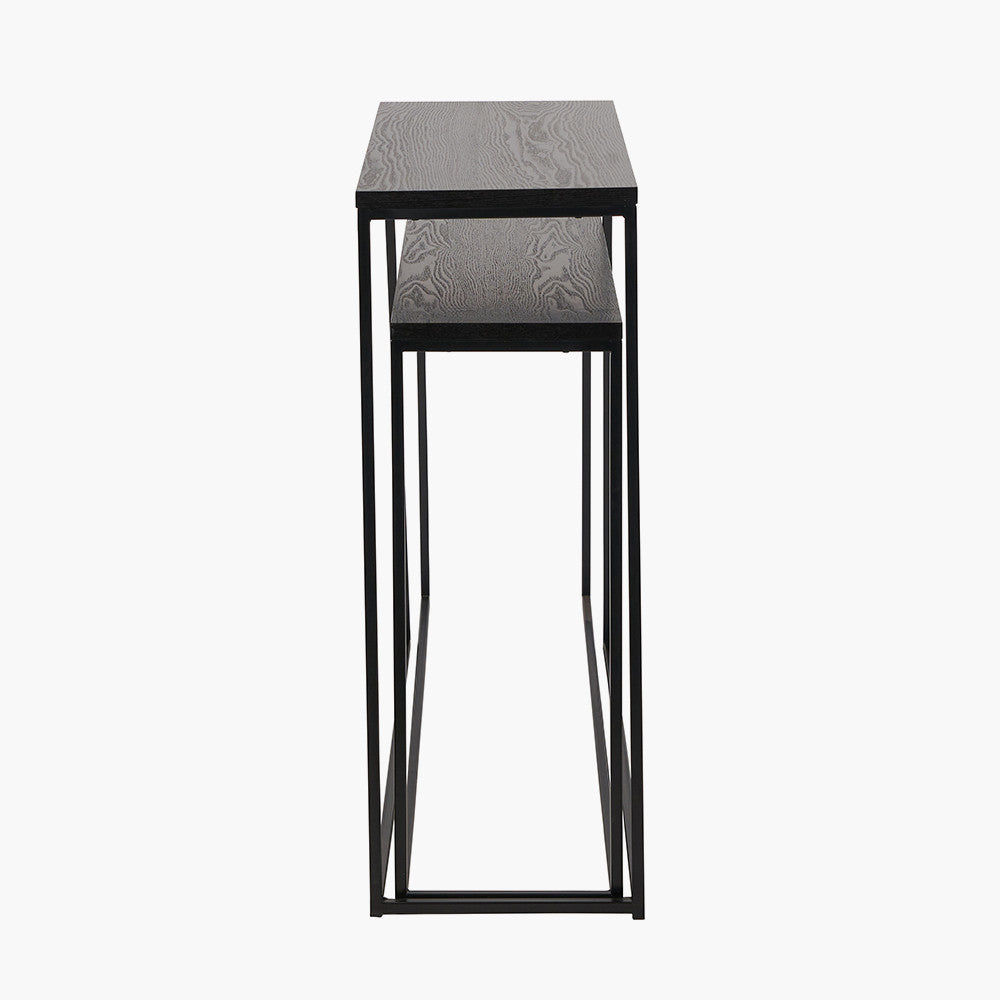Add bold style and adaptability to your home with the Mashiko Black Ash Veneer and Black Metal Console Tables. Set of two versatile tables with sleek black ash veneer tops. Shop online today at www.nobleandnook.co.uk