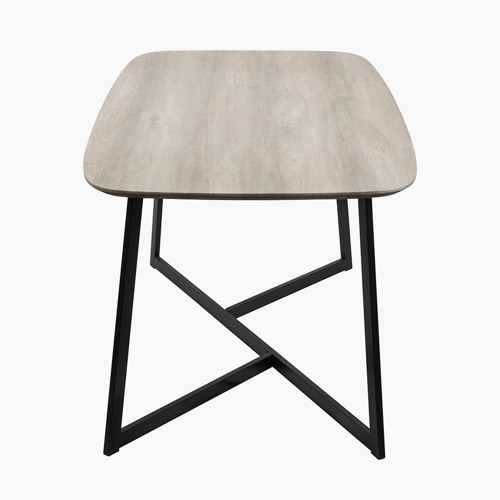 Ukiah Grey Oak Veneer and Black Metal Dining Table, featuring a grey oak veneer top with soft, rounded edges, paired with sturdy black metal legs. W180xD91xH76cm. Available at www.nobelandnook.co.uk