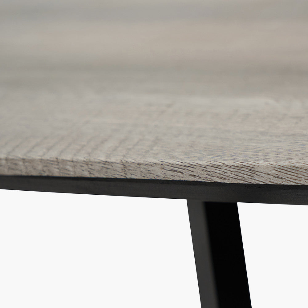 Ukiah Grey Oak Veneer and Black Metal Dining Table, featuring a grey oak veneer top with soft, rounded edges, paired with sturdy black metal legs. W180xD91xH76cm. Available at www.nobelandnook.co.uk