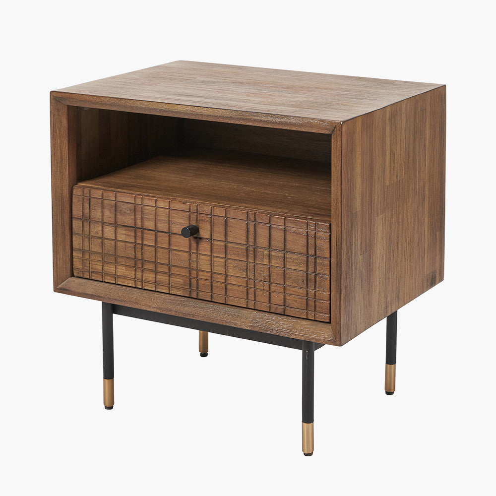 Shop the Arte Bedside Unit in dark brown acacia wood with etched detailing and sleek black metal legs, one drawer and open niche offer ample storage for essentials. Shop online today at www.nobleandnook.co.uk