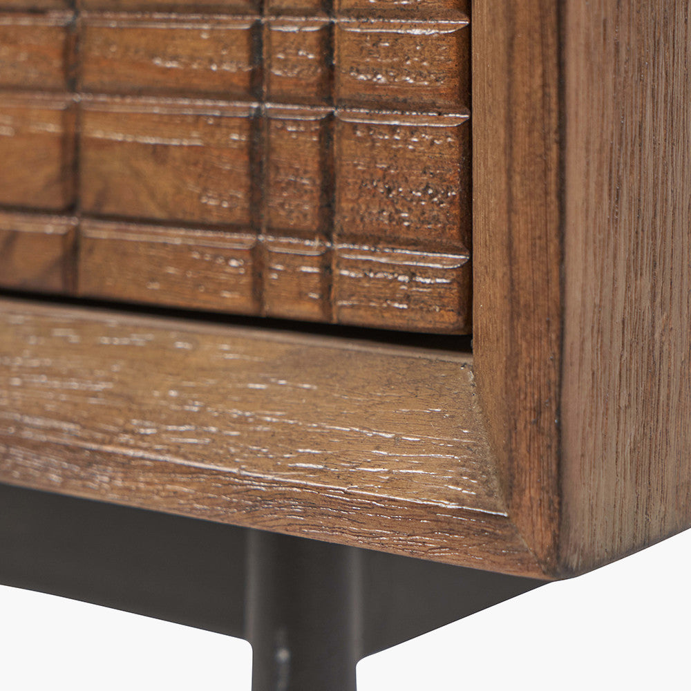 Shop the Arte Bedside Unit in dark brown acacia wood with etched detailing and sleek black metal legs, one drawer and open niche offer ample storage for essentials. Shop online today at www.nobleandnook.co.uk