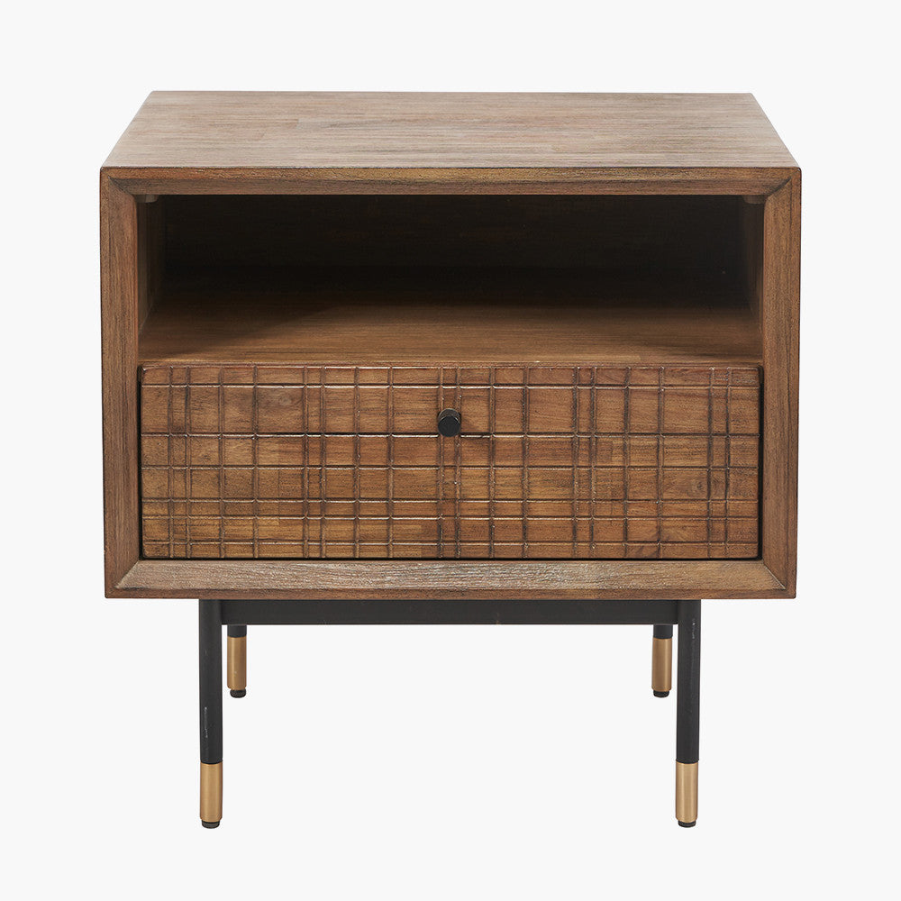 Shop the Arte Bedside Unit in dark brown acacia wood with etched detailing and sleek black metal legs, one drawer and open niche offer ample storage for essentials. Shop online today at www.nobleandnook.co.uk