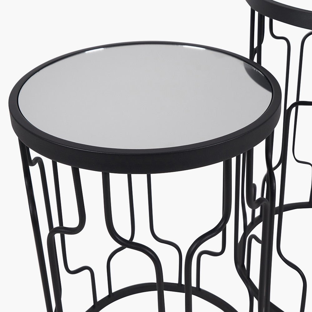 Set of Two Elegant Art Deco Design Side Tables – Includes one large and one small table for versatile styling. Black metal frames with circular silhouettes and mirrored glass tops. Available at www.nobleandnook.co.uk