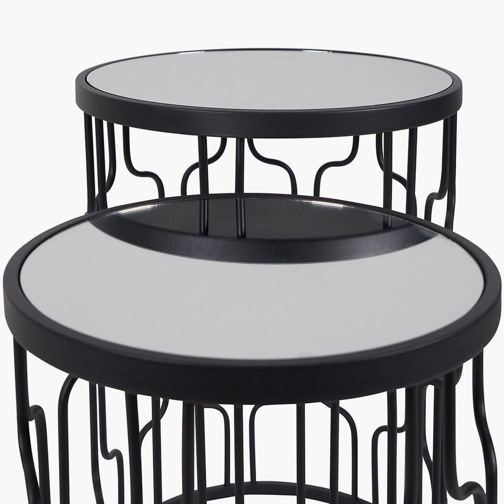 Set of Two Elegant Art Deco Design Side Tables – Includes one large and one small table for versatile styling. Black metal frames with circular silhouettes and mirrored glass tops. Available at www.nobleandnook.co.uk