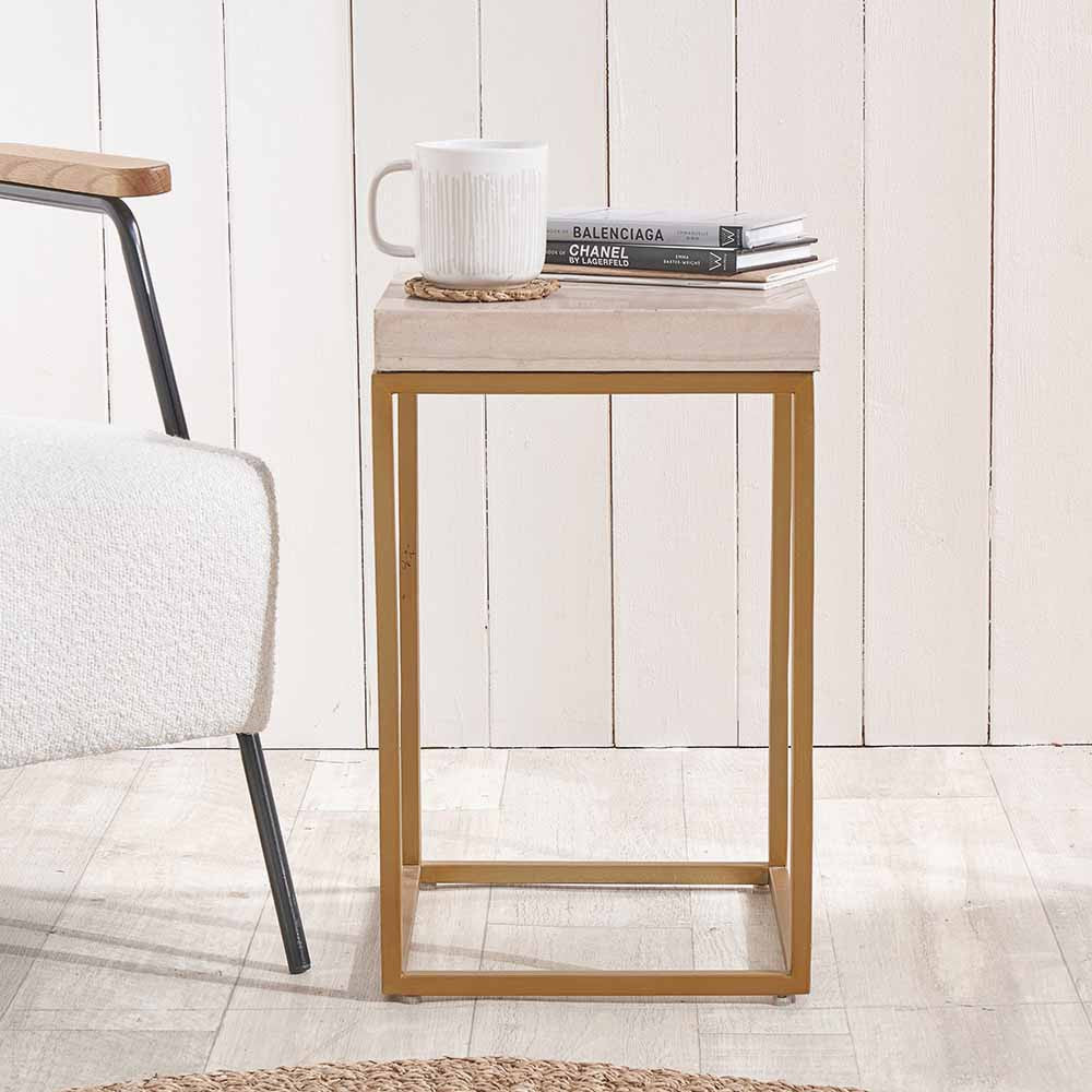 Shop the Madison side table, a contemporary design with warm burnished gold legs and a beige granite top. A luxurious addition to your home decor. Shop online today at www.nobleandnook.co.uk