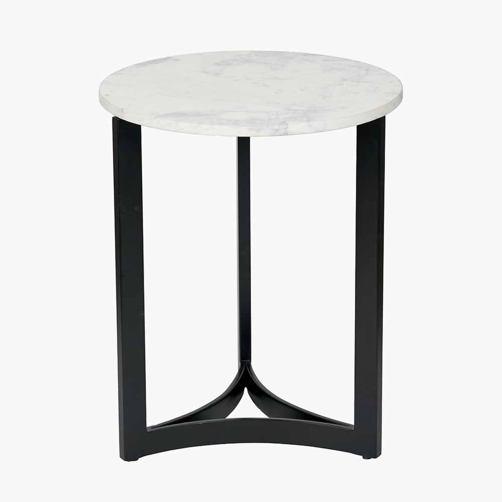 This striking Side Table pairs a luxurious marble top with gracefully curved black metal legs, creating a sophisticated contrast of texture and form. Dimensions W46xD46xH56cm. Shop online today at www.nobleandnook.co.uk