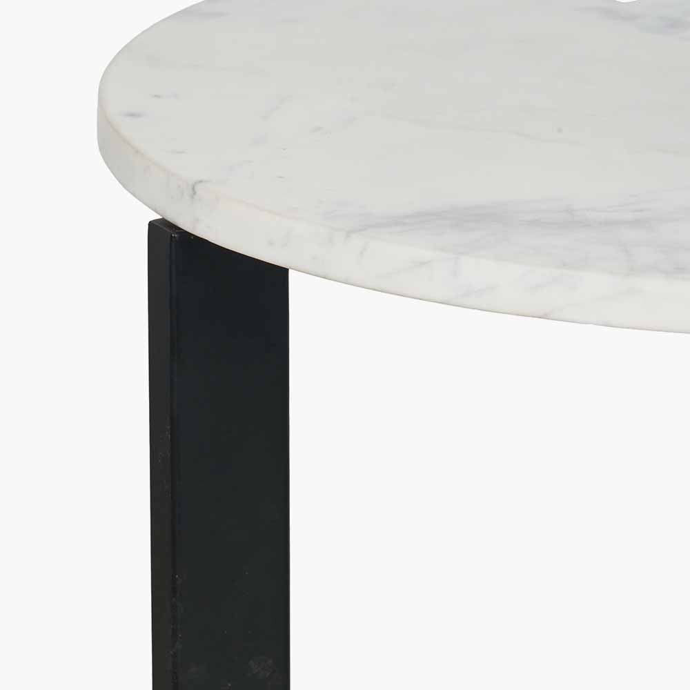 This striking Side Table pairs a luxurious marble top with gracefully curved black metal legs, creating a sophisticated contrast of texture and form. Dimensions W46xD46xH56cm. Shop online today at www.nobleandnook.co.uk