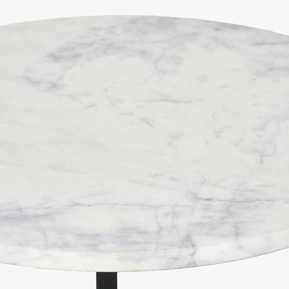 This striking Side Table pairs a luxurious marble top with gracefully curved black metal legs, creating a sophisticated contrast of texture and form. Dimensions W46xD46xH56cm. Shop online today at www.nobleandnook.co.uk