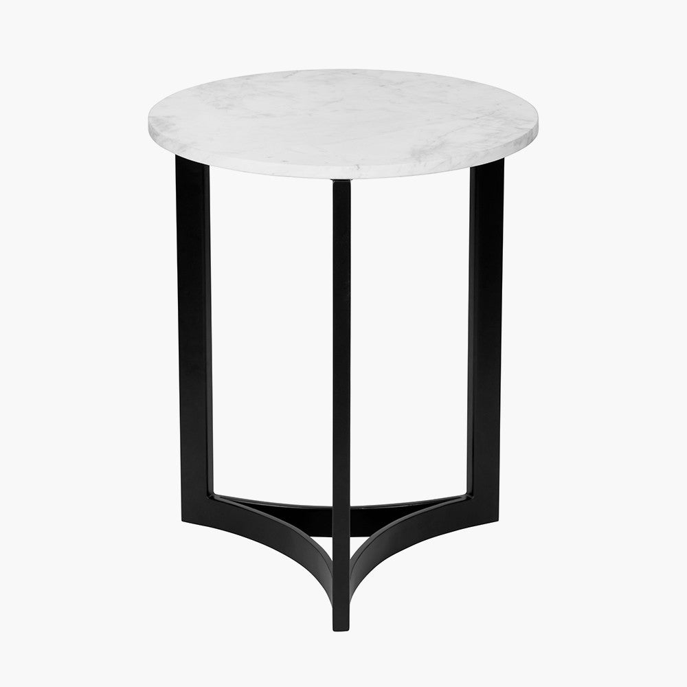 This striking Side Table pairs a luxurious marble top with gracefully curved black metal legs, creating a sophisticated contrast of texture and form. Dimensions W46xD46xH56cm. Shop online today at www.nobleandnook.co.uk