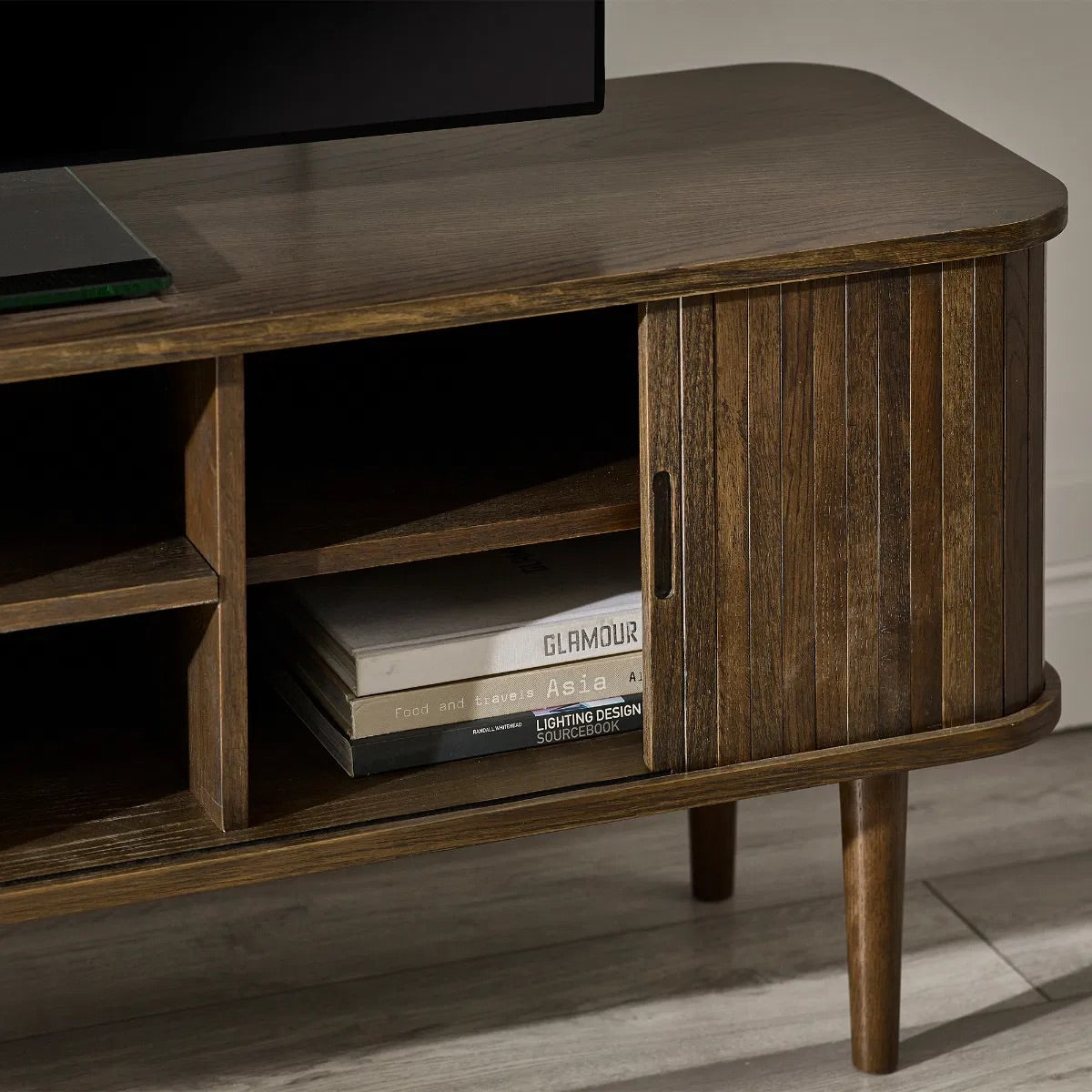 Elevate your living room with the Arya TV Media Unit in refined dark oak effect finish with sliding slatted doors. Perfect for modern homes. Shop online today at www.nobleandnook.co.uk