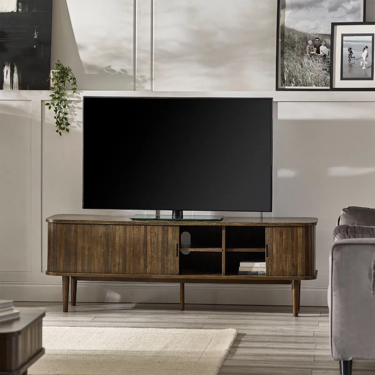 Elevate your living room with the Arya TV Media Unit in refined dark oak effect finish with sliding slatted doors. Perfect for modern homes. Shop online today at www.nobleandnook.co.uk
