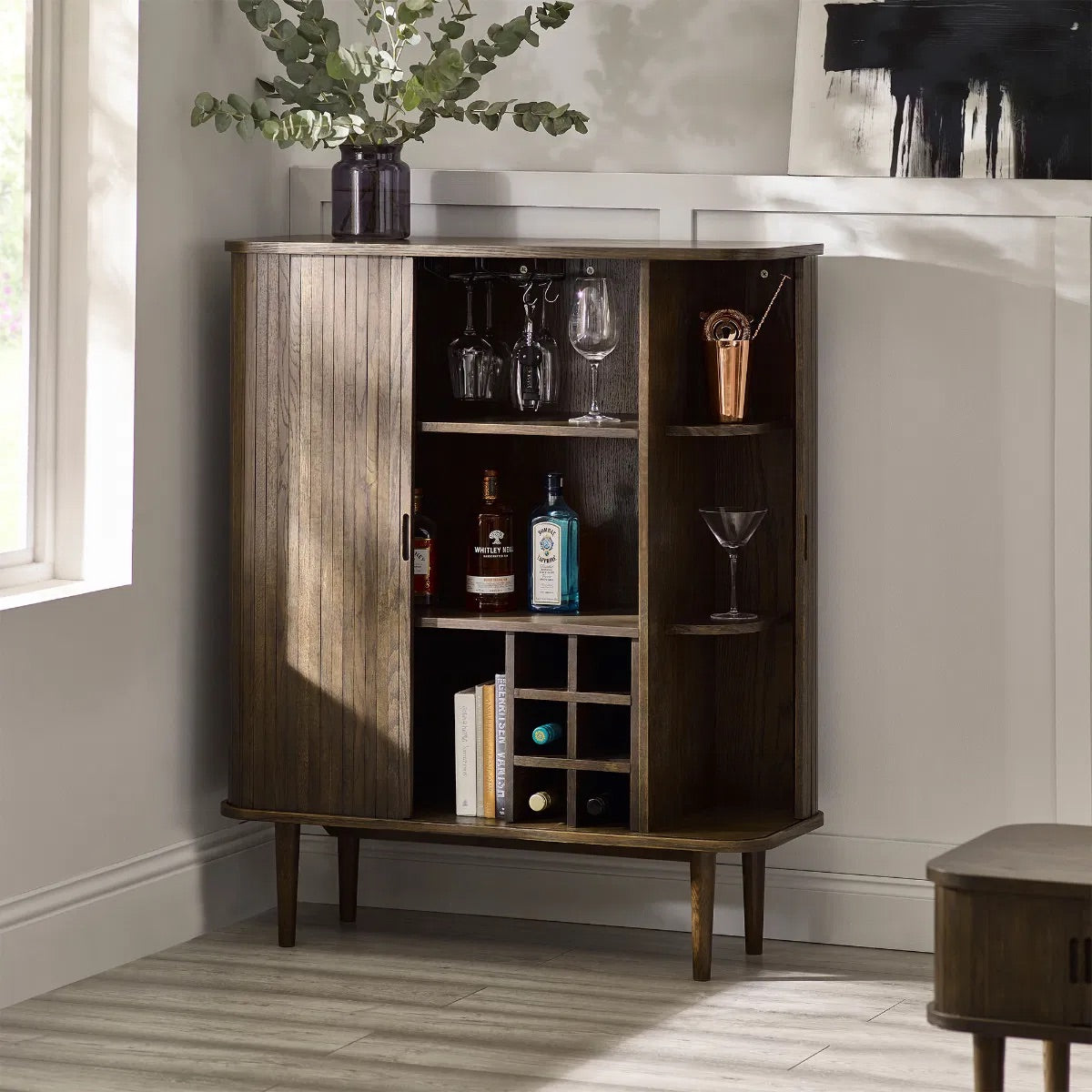 Add a touch of elegance and functionality to your entertaining space with the Arya Drinks Cabinet with sliding tambour doors reveal a well-designed interior. Available today at www.nobleandnook.co.uk