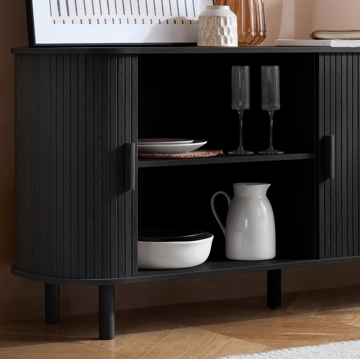 Elevate your interior with this 2 Door Fluted Sideboard, blending contemporary elegance with practical design and black finish adds sophistication to any room. Shop online at www.nobleandnook.co.uk