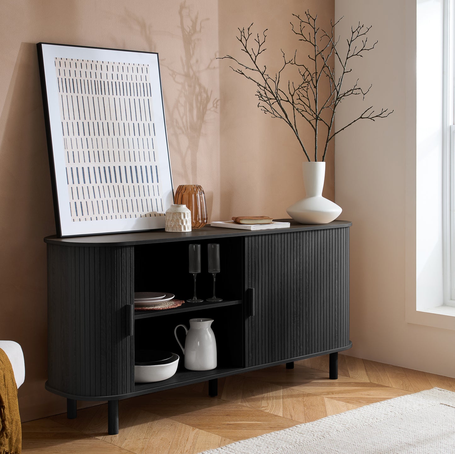 Elevate your interior with this 2 Door Fluted Sideboard, blending contemporary elegance with practical design and black finish adds sophistication to any room. Shop online at www.nobleandnook.co.uk