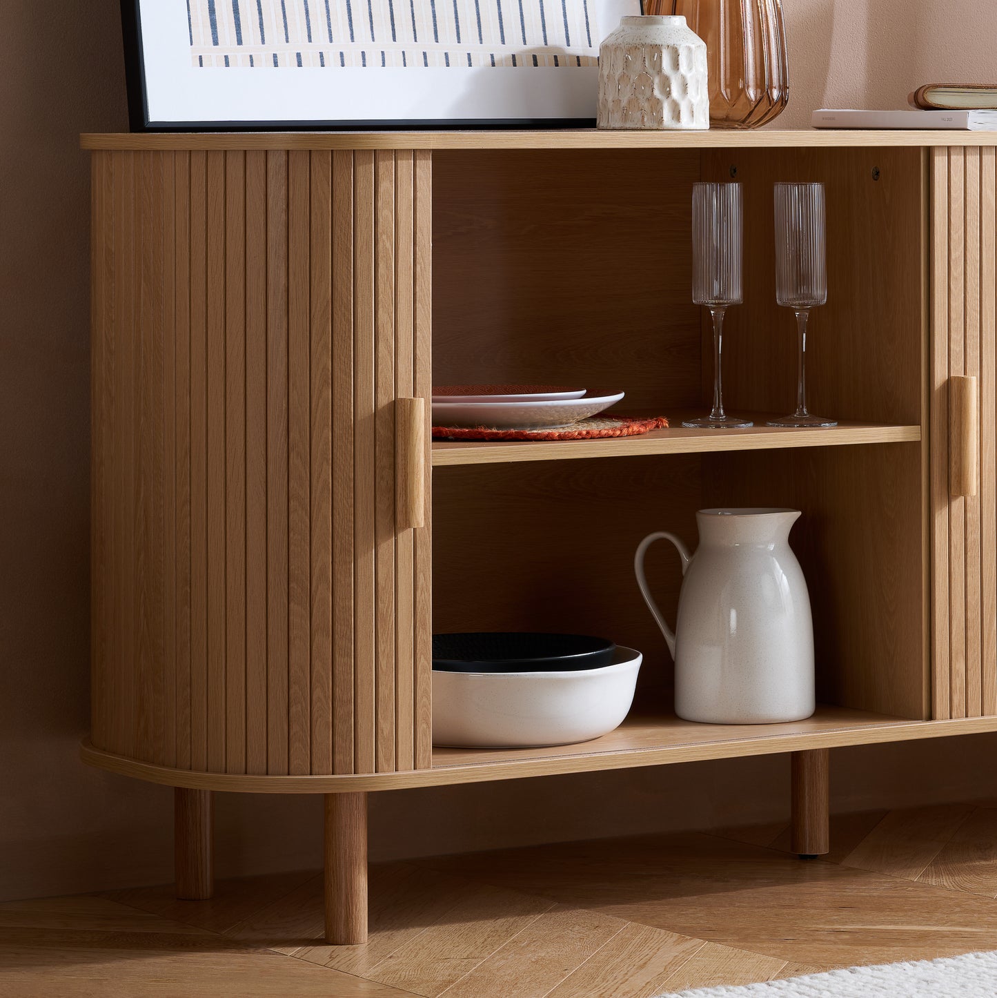 Elevate your interior with this 2 Door Fluted Sideboard, blending contemporary elegance with practical design and an oak finish adds warmth and sophistication to any room. Shop online at www.nobleandnook.co.uk