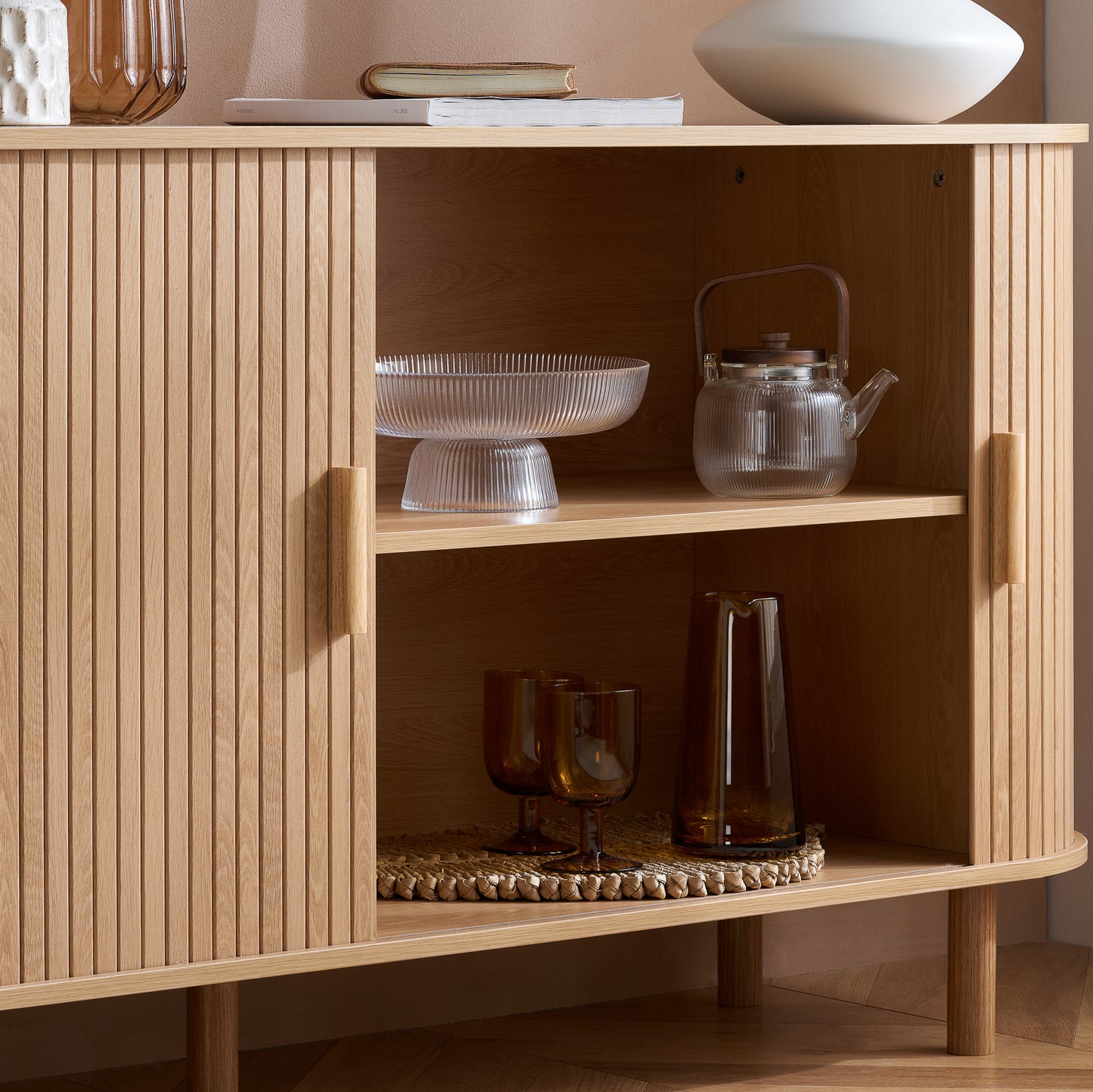 Elevate your interior with this 2 Door Fluted Sideboard, blending contemporary elegance with practical design and an oak finish adds warmth and sophistication to any room. Shop online at www.nobleandnook.co.uk