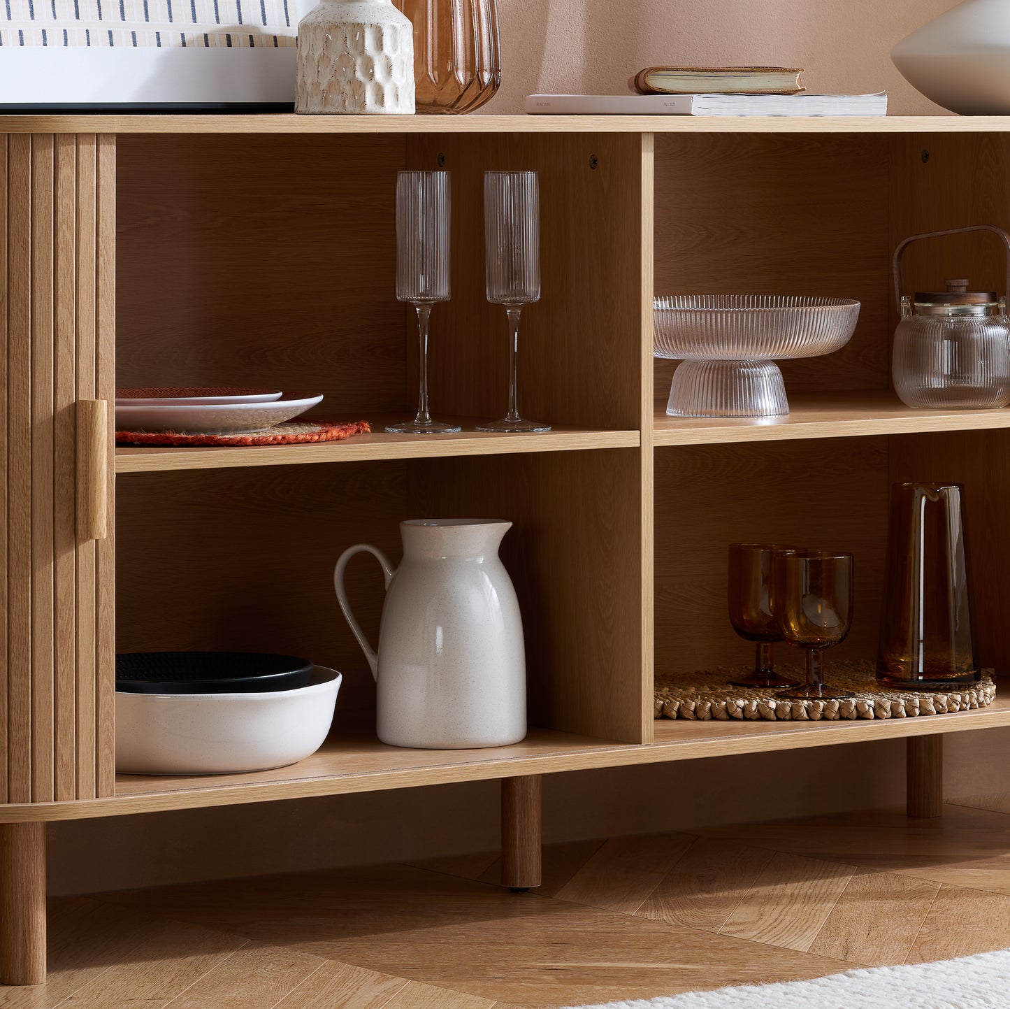 Elevate your interior with this 2 Door Fluted Sideboard, blending contemporary elegance with practical design and an oak finish adds warmth and sophistication to any room. Shop online at www.nobleandnook.co.uk
