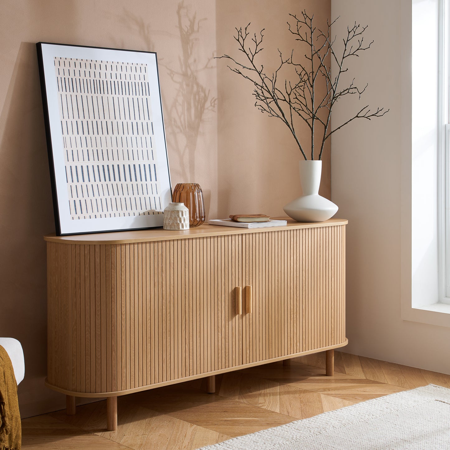 Elevate your interior with this 2 Door Fluted Sideboard, blending contemporary elegance with practical design and an oak finish adds warmth and sophistication to any room. Shop online at www.nobleandnook.co.uk