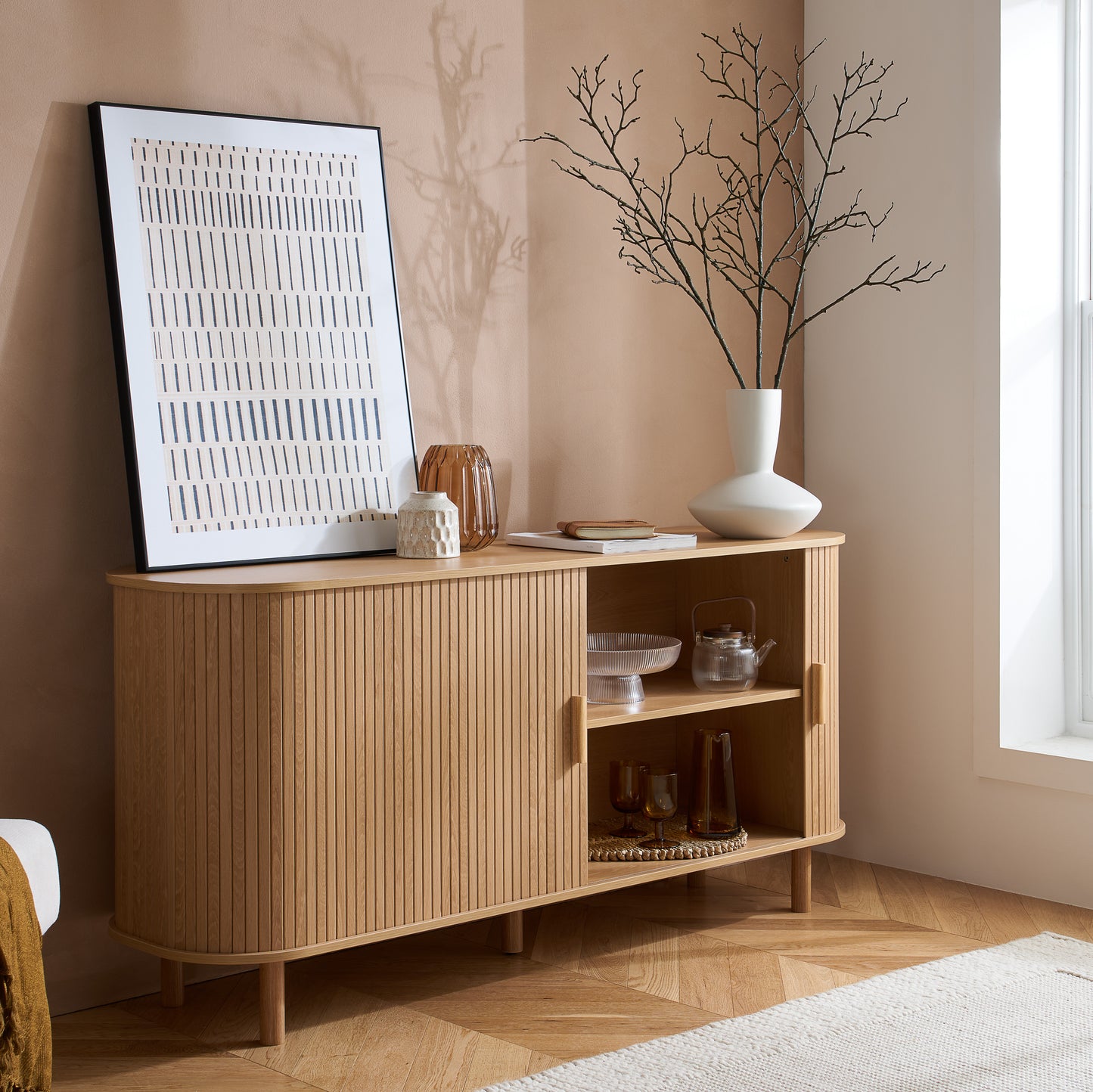 Elevate your interior with this 2 Door Fluted Sideboard, blending contemporary elegance with practical design and an oak finish adds warmth and sophistication to any room. Shop online at www.nobleandnook.co.uk