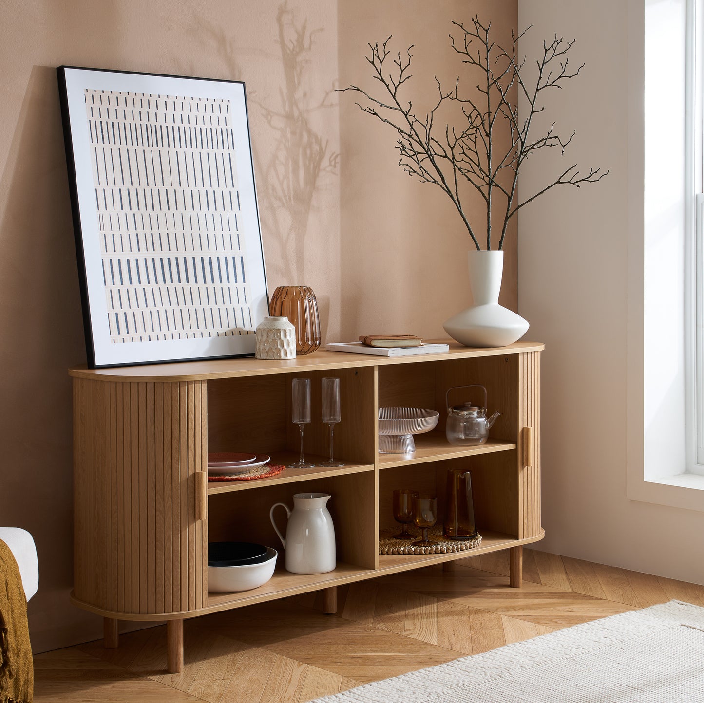 Elevate your interior with this 2 Door Fluted Sideboard, blending contemporary elegance with practical design and an oak finish adds warmth and sophistication to any room. Shop online at www.nobleandnook.co.uk