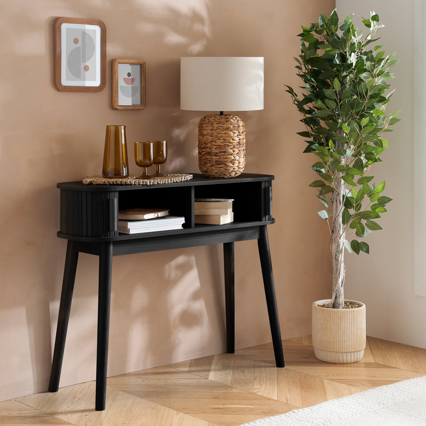 Elevate your interior with the Axel Console Table in Black. This stylish table features exquisite fluted detailing, adds depth and sophistication to any living space. Shop online today at www.nobleandnook.co.uk