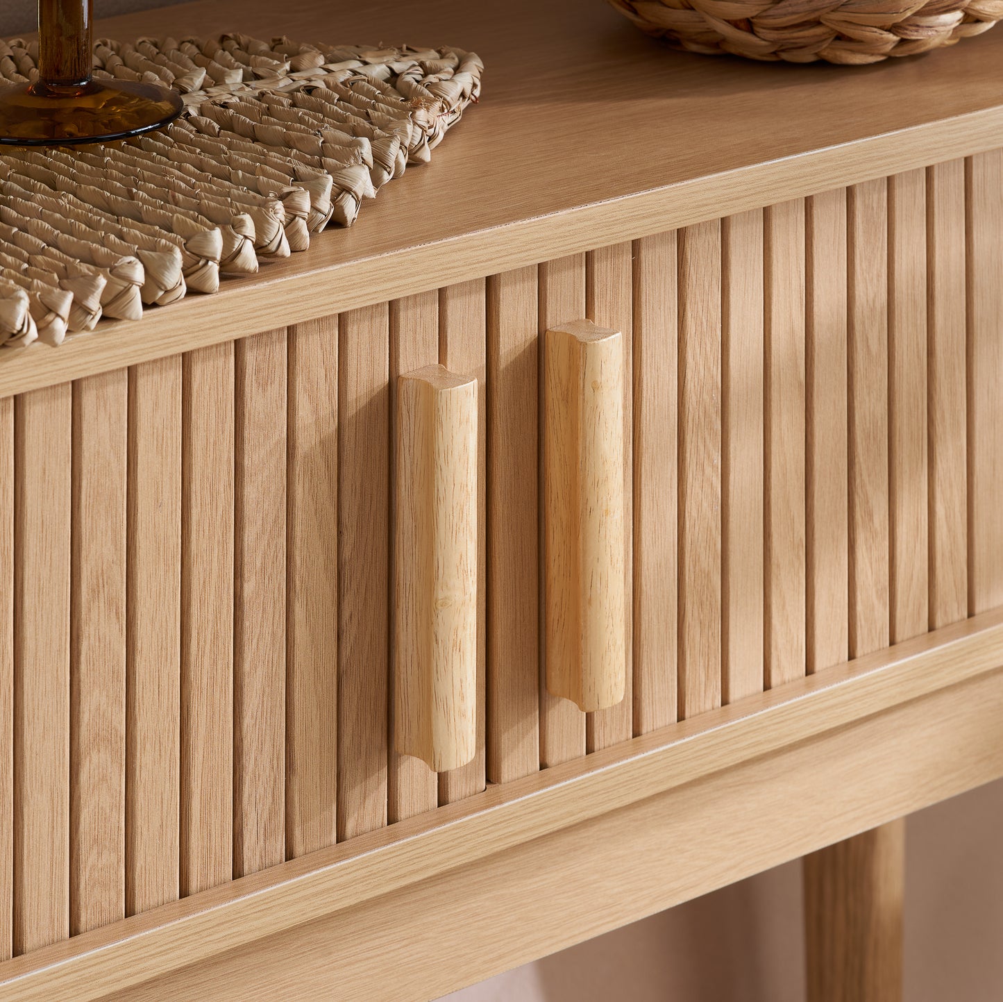 Elevate your interior with the Axel Console Table in an Oak Finish. This stylish table features exquisite fluted detailing, adds depth and sophistication to any living space. Shop online today at www.nobleandnook.co.uk