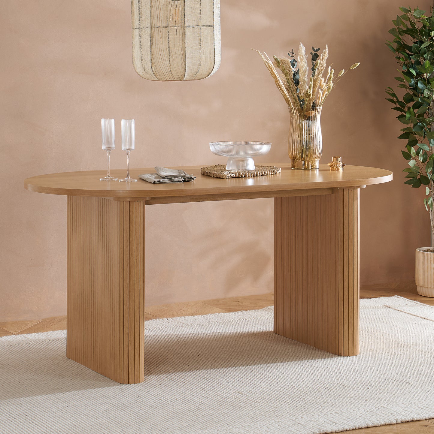 Crafted from premium MDF and available in two stylish finishes, oak or black, this oval table features beautiful fluted detailing that creates a modern, refined look. Shop online today at www.nobleandnook.co.uk