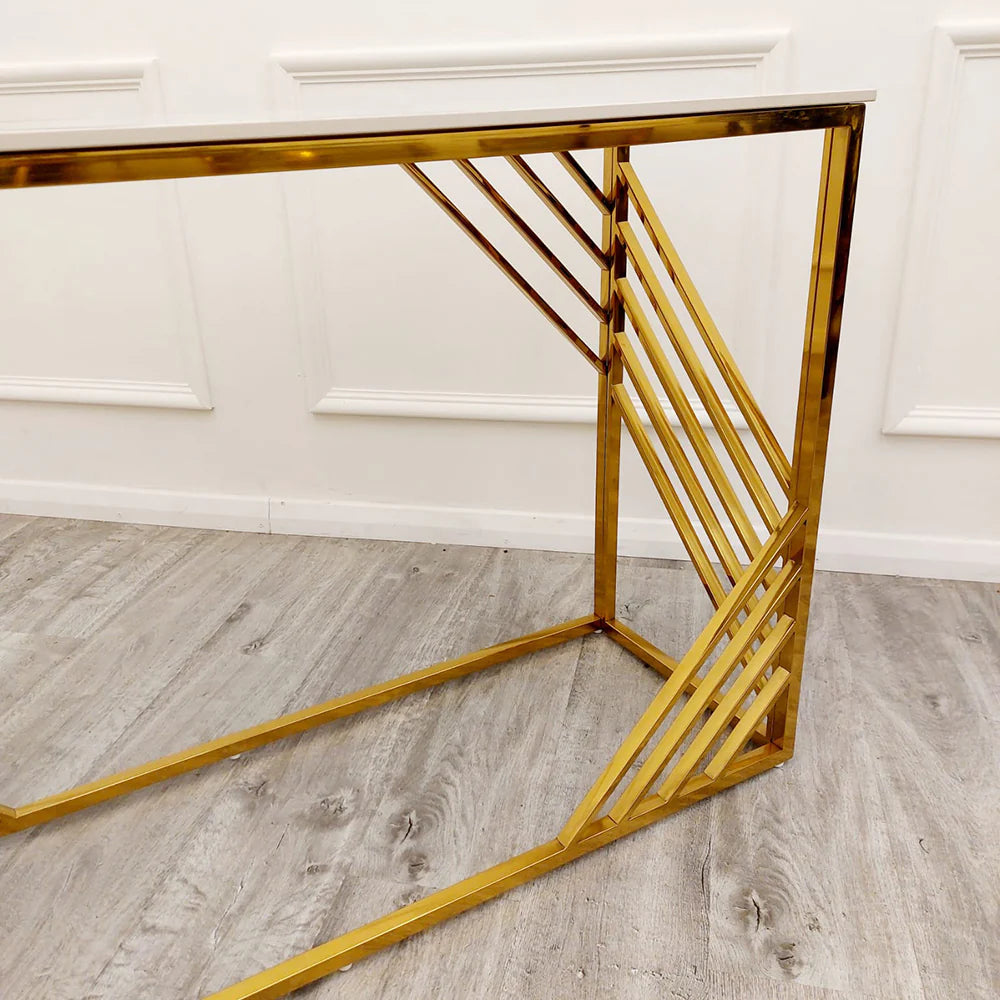 Shop now to redefine your interior design with the Azure Console Table. Featuring a gold tone frame with a Polar White Sintered Stone top. Perfectly suited for entrances and hallways. Shop online today at www.nobleandnook.co.uk