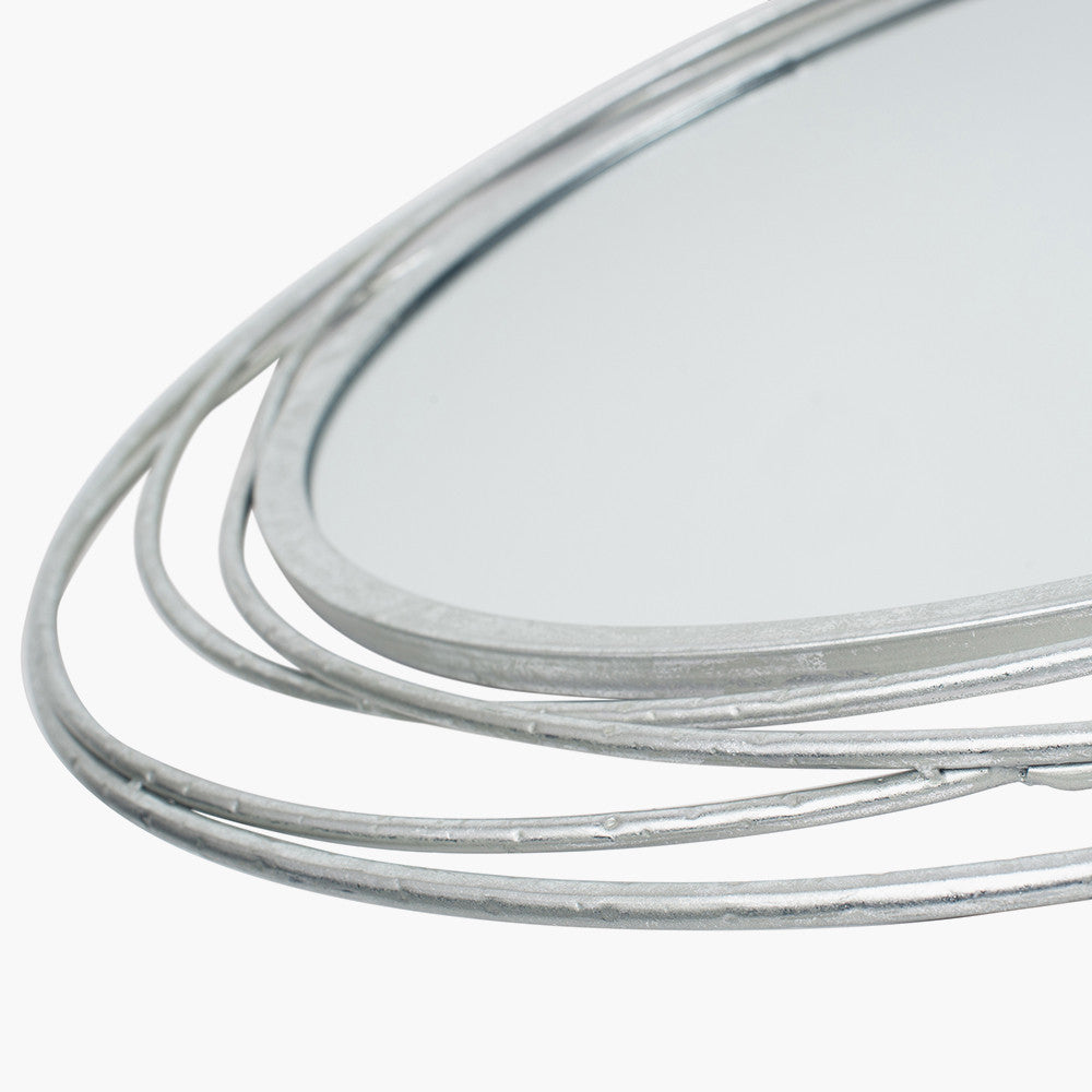 Featuring delicate swirling metalwork finished in a stunning antique silver, this mirror brings light, depth, and elegance to your space. Shop online now at www.nobleandnook.co.uk