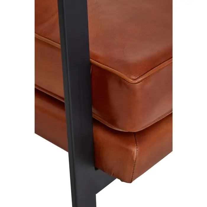This Buffalo Tan Leather Armchair features genuine tan leather upholstery and a sleek black iron frame, offering both comfort and durability. Free UK Mainland Delivery. Shop online today at www.nobleandnook.co.uk