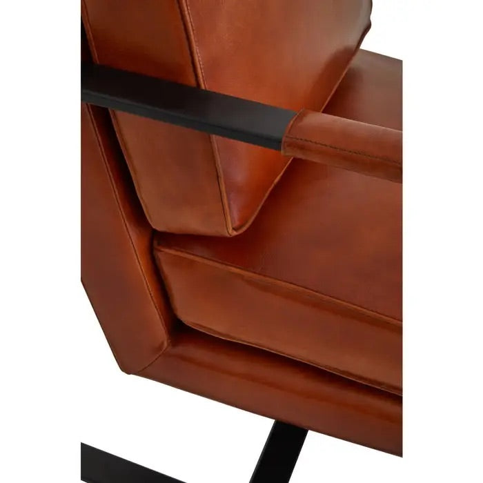 This Buffalo Tan Leather Armchair features genuine tan leather upholstery and a sleek black iron frame, offering both comfort and durability. Free UK Mainland Delivery. Shop online today at www.nobleandnook.co.uk