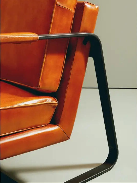 This Buffalo Tan Leather Armchair features genuine tan leather upholstery and a sleek black iron frame, offering both comfort and durability. Free UK Mainland Delivery. Shop online today at www.nobleandnook.co.uk