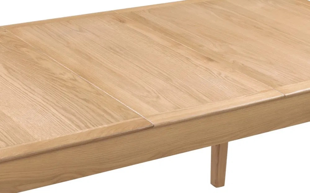 The Cotswold Extending Dining Table, crafted from solid oak and oak veneers, making it a standout piece for both classic and contemporary interiors. Ideal for family dining or entertaining guests