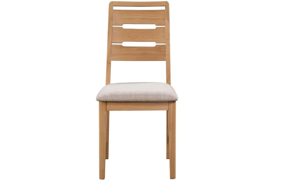 Enhance your dining space with the Elara Dining Chair, expertly crafted from solid oak for a blend of durability and natural beauty. Shop online today at www.nobleandnook.co.uk